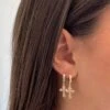 SMALL CROSS HUGGIE HOOPS